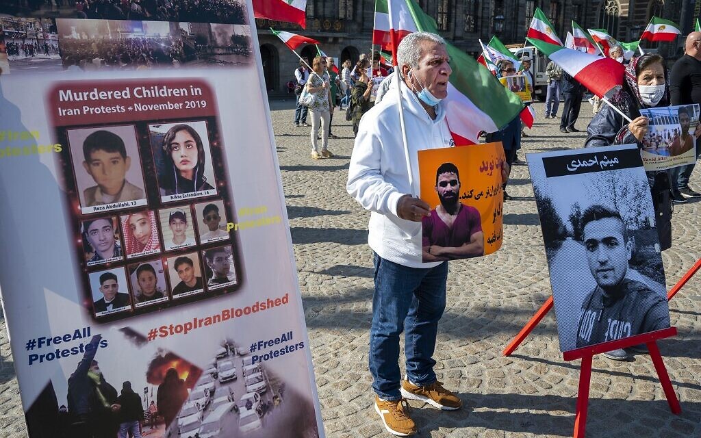 A man holds a portrait of Iranian wrestler Navid Afkari during a demonstration against his execution during a protest held on the Dam Square in Amsterdam, September 13, 2020. (Evert Elzinga/ANP/AFP) A man holds a portrait of Iranian wrestler Navid Afkari during a demonstration against his execution during a protest held on the Dam Square in Amsterdam, September 13, 2020. (Evert Elzinga/ANP/AFP)