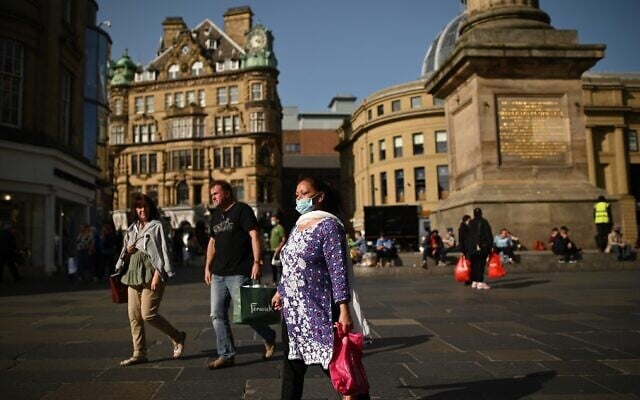 Pedestrians and shoppers, some wearing face masks due to the coronavirus pandemic, walk in Newcastle city center, northeast England, on September 17, 2020. (Oli Scarff/AFP) Pedestrians and shoppers, some wearing face masks due to the coronavirus pandemic, walk in Newcastle city center, northeast England, on September 17, 2020. (Oli Scarff/AFP)