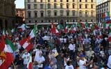 Supporters hold Italian flags during a center-right coalition rally of the Lega, Brothers of Italy and Forza Italia parties for the regional elections, on September 18, 2020, in Florence, Tuscany. (Carlo Bressan/AFP)