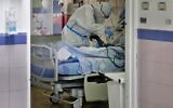 Illustrative image: Medical staff in the COVID-19 isolation ward at Barzilai Medical Center in the southern city of Ashkelon (Gil Cohen-Magen/AFP)