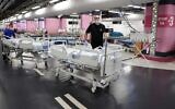 Technicians prepare beds in the underground parking of Rambam Health Care Campus which was transformed into an intensive care facility for coronavirus patients, in the northern Israeli city of Haifa on September 23, 2020.(Photo by JACK GUEZ / AFP)