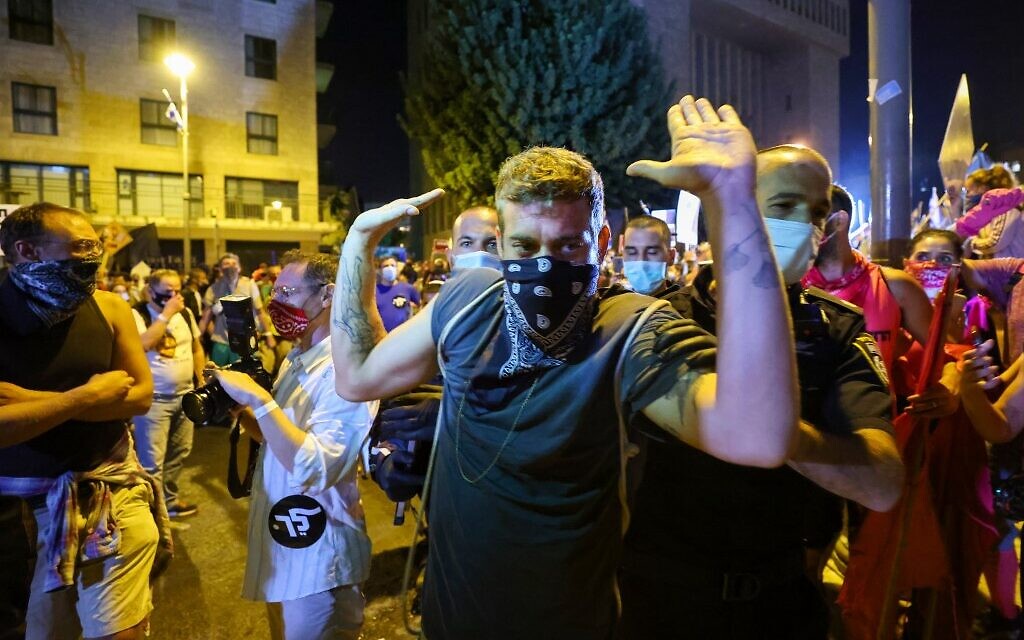 Israeli police detain a protester during a demonstration in Jerusalem, on September 26, 2020. (EMMANUEL DUNAND / AFP) Israeli police detain a protester during a demonstration in Jerusalem, on September 26, 2020. (EMMANUEL DUNAND / AFP)