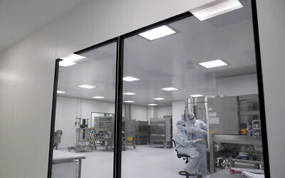 Laboratory technicians work at the mAbxience biopharmaceutical company on an experimental coronavirus vaccine developed by Oxford University and the laboratory AstraZeneca in Garin, Argentina, August 14, 2020. (Natacha Pisarenko/AP)