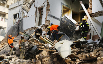 Chilean and Lebanese rescuers search in the rubble of a building that was collapsed in last month's massive explosion,  after getting signals there may be a survivor under the rubble, in Beirut, Lebanon on September 3, 2020. (AP/Bilal Hussein)