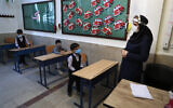 Students and their teacher attend class after the opening ceremony of the Hashtroudi school in Tehran, Iran, September 5, 2020. (AP Photo/Vahid Salemi)