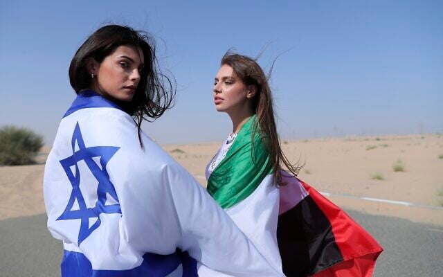 Israeli model May Tager, left, covers herself with an Israeli flag next to Anastasia Bandarenka, a Dubai-based model who covers herself in a UAE flag on the set of a photo shoot in Dubai, United Arab Emirates, Sunday, September 8, 2020. (AP Photo/Kamran Jebreili) Israeli model May Tager, left, covers herself with an Israeli flag next to Anastasia Bandarenka, a Dubai-based model who covers herself in a UAE flag on the set of a photo shoot in Dubai, United Arab Emirates, Sunday, September 8, 2020. (AP Photo/Kamran Jebreili)