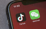 Icons for the smartphone apps TikTok and WeChat are seen on a smartphone screen in Beijing. (AP Photo/Mark Schiefelbein)