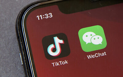 Icons for the smartphone apps TikTok and WeChat are seen on a smartphone screen in Beijing. (AP Photo/Mark Schiefelbein)