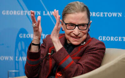 US Supreme Court Justice Ruth Bader Ginsburg applauds after a performance in her honor after she spoke about her life and work during a discussion at Georgetown Law School in Washington, April 6, 2018. (AP Photo/Alex Brandon, File)