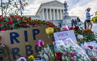 People gather at the US Supreme Court on the morning after the death of Justice Ruth Bader Ginsburg, 87, Saturday, Sept. 19, 2020 in Washington. (AP Photo/J. Scott Applewhite)