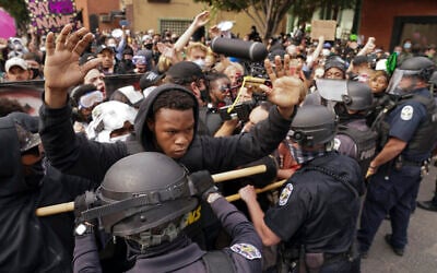 Police and protesters converge during a demonstration on September 23, 2020, in Louisville, Kentucky. (AP Photo/John Minchillo)
