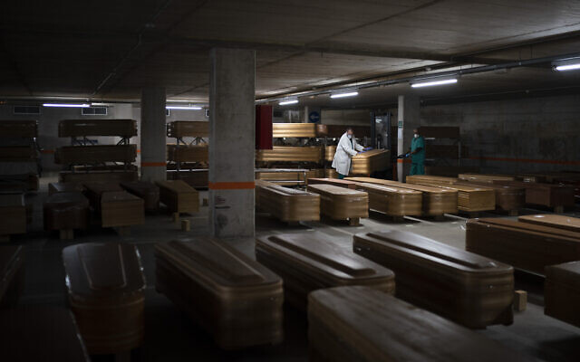 Coffins carrying the bodies of people who died of coronavirus are stored waiting to be buried or incinerated in an underground parking lot at the Collserola funeral home in Barcelona, Spain, April 2, 2020. (AP/Felipe Dana)