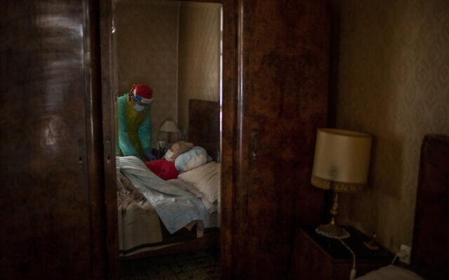 Josefa Ribas, 86, who is bedridden and suffers from dementia, is attended to by nurse Laura Valdes during a home care visit in Barcelona, Spain, April 7, 2020. Ribas' husband, Jose Marcos, fears what will happen if the virus enters their home and infects them. 'I survived the post-war period (of mass hunger). I hope I survive this pandemic,' he said. (AP/Emilio Morenatti)