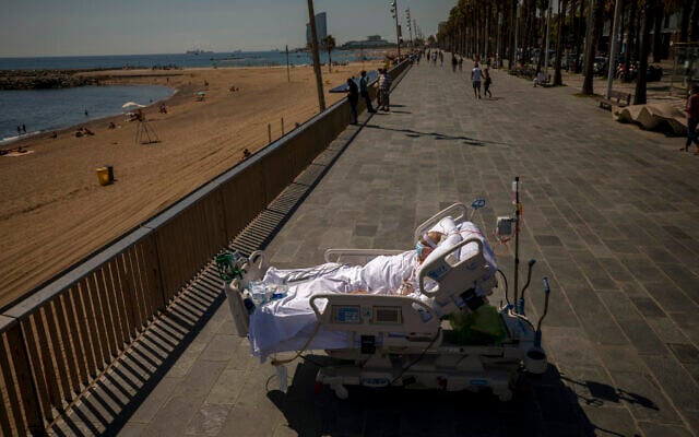 Francisco Espana, 60, looks at the Mediterranean sea from a promenade next to the Hospital del Mar in Barcelona, Spain, Friday, Sept. 4, 2020. Francisco spent 52 days in the Intensive Care unit at the hospital due to coronavirus, but he was allowed by his doctors to spend almost ten minutes at the seaside as part of his recovery therapy. (AP/Emilio Morenatti)