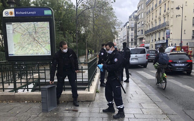 Police officers stand by a knife, seen on the ground, in Paris, September 25, 2020. (Soufian Fezzani Via AP) Police officers stand by a knife, seen on the ground, in Paris, September 25, 2020. (Soufian Fezzani Via AP)