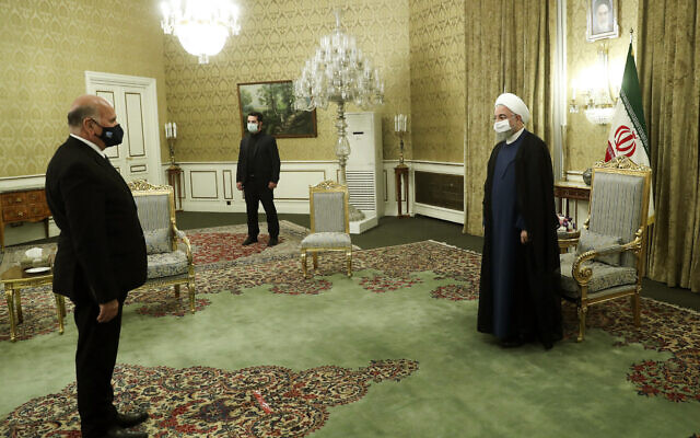 In this photo released by the official website of the office of the Iranian Presidency, President Hassan Rouhani, right, welcomes Iraqi Foreign Minister Fuad Hussein for their meeting, in Tehran, Iran, September 26, 2020. (Iranian Presidency Office via AP) In this photo released by the official website of the office of the Iranian Presidency, President Hassan Rouhani, right, welcomes Iraqi Foreign Minister Fuad Hussein for their meeting, in Tehran, Iran, September 26, 2020. (Iranian Presidency Office via AP)