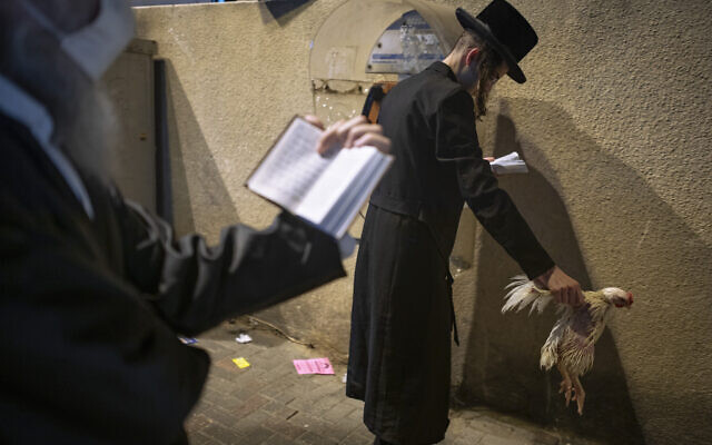 An ultra-Orthodox Jewish man holds a chicken as part of the Kaparot ritual, in Bnei Brak, September 27, 2020. (AP Photo/Oded Balilty) An ultra-Orthodox Jewish man holds a chicken as part of the Kaparot ritual, in Bnei Brak, September 27, 2020. (AP Photo/Oded Balilty)