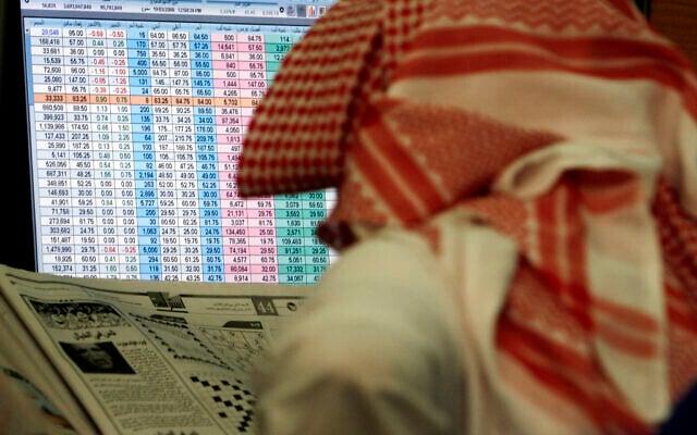 A Saudi man reads a newspaper while keeping an eye on a screen displaying stock market figures, at al Jazeera Capital Bank in Riyadh, Saudi Arabia, March 19, 2008. (Hasan Jamali/AP) A Saudi man reads a newspaper while keeping an eye on a screen displaying stock market figures, at al Jazeera Capital Bank in Riyadh, Saudi Arabia, March 19, 2008. (Hasan Jamali/AP)