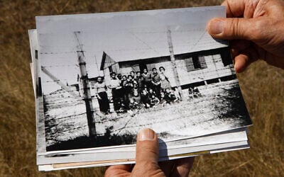 Retired schoolteacher Jacques Sigot shows photos taken of unidentified inmates of a camp where thousands of French Gypsies were interned in the village of Montreuil-Bellay, in the Saumur wine region, during World War II,  Sept. 8, 2010 (AP Photo/Michel Euler)
