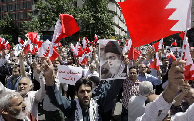 Illustrative: Iranians wave Bahraini flags as they chant slogans during a demonstration in Tehran, Iran, May 18, 2012 (AP Photo/Vahid Salemi) Illustrative: Iranians wave Bahraini flags as they chant slogans during a demonstration in Tehran, Iran, May 18, 2012 (AP Photo/Vahid Salemi)