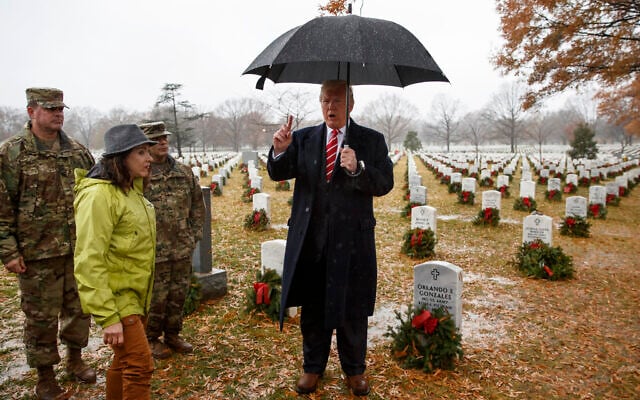 US President Donald Trump speaks as he visits Section 60 at Arlington National Cemetery in Arlington, Va., Saturday, Dec. 15, 2018, during Wreaths Across America Day. (AP Photo/Carolyn Kaster) US President Donald Trump speaks as he visits Section 60 at Arlington National Cemetery in Arlington, Va., Saturday, Dec. 15, 2018, during Wreaths Across America Day. (AP Photo/Carolyn Kaster)