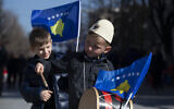 A boy plays on a drum decorated with Kosovo's flag to celebrate the 12th anniversary of the country's independence, in the capital Pristina, Monday, Feb. 17, 2020. (AP/Visar Kryeziu)