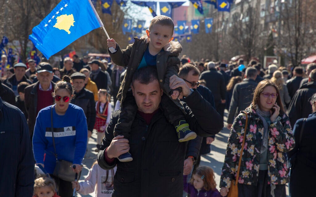 A father holds his son waving Kosovo's flag as they celebrate the 12th anniversary of the country's independence, in the capital Pristina, Monday, Feb. 17, 2020 (AP Photo/Visar Kryeziu) A father holds his son waving Kosovo's flag as they celebrate the 12th anniversary of the country's independence, in the capital Pristina, Monday, Feb. 17, 2020 (AP Photo/Visar Kryeziu)