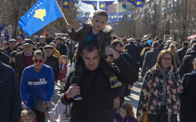 A father holds his son waving Kosovo's flag as they celebrate the 12th anniversary of the country's independence, in the capital Pristina, Monday, Feb. 17, 2020 (AP Photo/Visar Kryeziu) A father holds his son waving Kosovo's flag as they celebrate the 12th anniversary of the country's independence, in the capital Pristina, Monday, Feb. 17, 2020 (AP Photo/Visar Kryeziu)