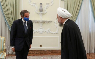 File: Iranian President Hassan Rouhani, right, welcomes Director General of International Atomic Energy Agency Rafael Mariano Grossi, for a meeting in Tehran, Iran, August 26, 2020. (Iranian Presidency Office via AP)