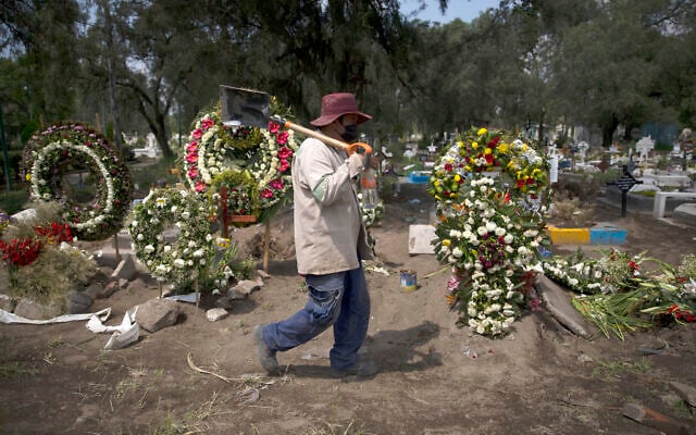 A grave digger walks in the COVID-19 section of the cemetery of San Lorenzo Tezonco Iztapalapa on the outskirts of Mexico City, Sept. 1, 2020. (AP Photo/Marco Ugarte) A grave digger walks in the COVID-19 section of the cemetery of San Lorenzo Tezonco Iztapalapa on the outskirts of Mexico City, Sept. 1, 2020. (AP Photo/Marco Ugarte)