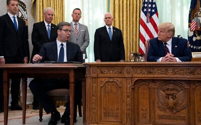 US President Donald Trump listens to Serbian President Aleksandar Vucic speak during a signing ceremony with Kosovar Prime Minister Avdullah Hoti, in the Oval Office of the White House, September 4, 2020, in Washington. (AP Photo/Evan Vucci)