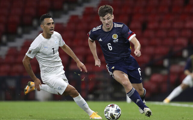 Scotland's Kieran Tierney, right and Israel's Eran Zahavi vie for the ball, during the UEFA Nations League Group F soccer match between Scotland and Israel, at Hampden Park, in Glasgow, Scotland, Friday, Sept. 4, 2020. (Andrew Milligan/PA via AP)