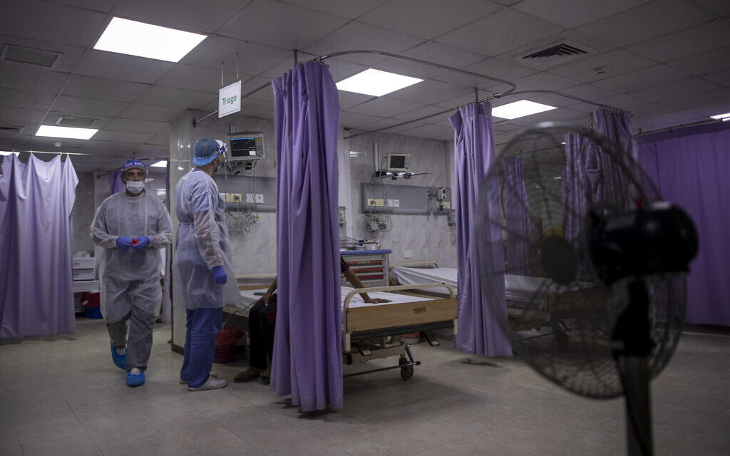 Palestinian doctors treat patients at the emergency room of the al-Quds Hospital in Gaza City, September 7, 2020. (Khalil Hamra/AP) Palestinian doctors treat patients at the emergency room of the al-Quds Hospital in Gaza City, September 7, 2020. (Khalil Hamra/AP)