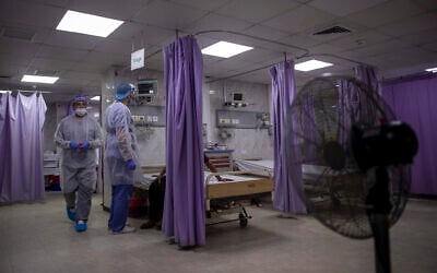 Palestinian doctors treat patients at the emergency room of the al-Quds Hospital in Gaza City, September 7, 2020. (Khalil Hamra/AP) Palestinian doctors treat patients at the emergency room of the al-Quds Hospital in Gaza City, September 7, 2020. (Khalil Hamra/AP)