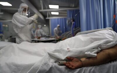 Illustrative: A COVID-19 patient lies face down as a nurse prepares an injection in the ICU of the National Hospital in Itagua, Paraguay, September 7, 2020. (AP Photo/Jorge Saenz)