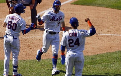 New York Mets' Jeff McNeil celebrates after hitting a home run during the seventh inning of a baseball game against the Philadelphia Phillies on Sept. 7, 2020, in New York. (AP Photo/Adam Hunger)