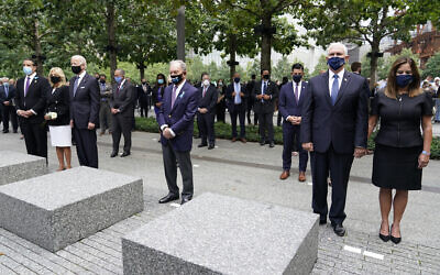 From left, New York Governor Andrew Cuomo, Jill Biden with her husband Democratic presidential candidate Joe Biden, former NYC Mayor Mike Bloomberg, Vice President Mike Pence and his wife Karen, observe a moment of silence during a ceremony organized by the Tunnel to Towers Foundation on September 11, 2020, in New York. (AP Photo/Mary Altaffer)