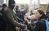Women gesture, standing in front of a police line during an opposition rally to protest the official presidential election results in Minsk, Belarus, Saturday, Sept. 12, 2020. (Tut.by via AP)
