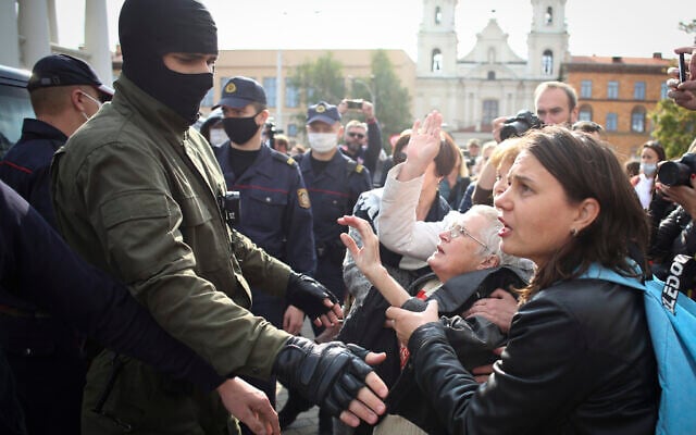 Women gesture, standing in front of a police line during an opposition rally to protest the official presidential election results in Minsk, Belarus, Saturday, Sept. 12, 2020. (Tut.by via AP) Women gesture, standing in front of a police line during an opposition rally to protest the official presidential election results in Minsk, Belarus, Saturday, Sept. 12, 2020. (Tut.by via AP)
