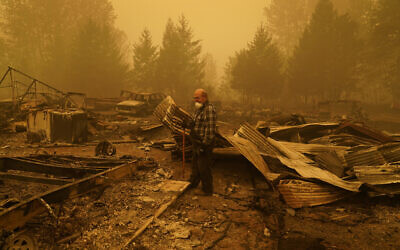 George Coble walks through what remains of a home on his property destroyed by a wildfire Saturday, Sept. 12, 2020, in Mill City, Ore. (AP/John Locher)