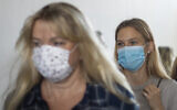 Israeli top model Bar Refaeli, right, and her mother, Tzipi Rafaieli wear face masks amid the coronavirus pandemic as they leave a courtroom in Tel Aviv, September 13, 2020 (AP Photo/Ariel Schalit, Pool)