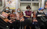 A family rides the train, Monday, September 14, 2020, in the Brooklyn borough of New York. (AP/Mary Altaffer)