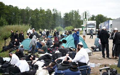 Jewish pilgrims sit on the Belarus-Ukraine border, in Belarus, Tuesday, Sept. 15, 2020. About 700 Jewish pilgrims are stuck on Belarus' border due to coroavirus restrictions that bar them from entering Ukraine. (TUT.by via AP)