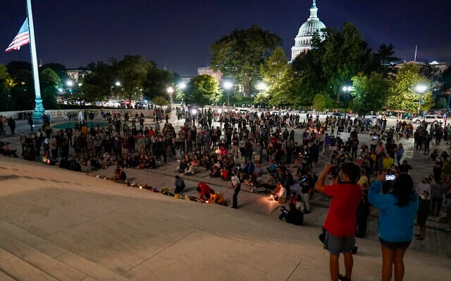 People gather at the Supreme Court, Sept. 18, 2020, in Washington, after the Supreme Court announced that Supreme Court Justice Ruth Bader Ginsburg has died of metastatic pancreatic cancer at age 87. (AP Photo/Alex Brandon)