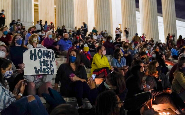 People gather at the Supreme Court Sept. 18, 2020, in Washington, after the Supreme Court announced that Supreme Court Justice Ruth Bader Ginsburg has died of metastatic pancreatic cancer at age 87. (AP Photo/Alex Brandon)