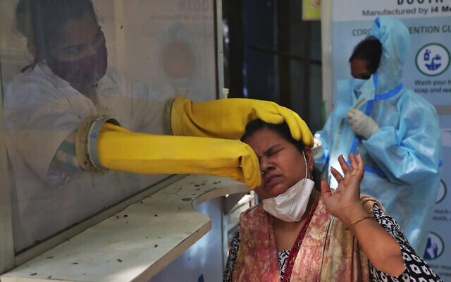 A health worker collects a nasal swab sample to test for COVID-19 in Hyderabad, India, Sept. 22, 2020 (AP Photo/Mahesh Kumar A.) A health worker collects a nasal swab sample to test for COVID-19 in Hyderabad, India, Sept. 22, 2020 (AP Photo/Mahesh Kumar A.)