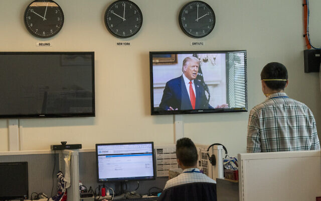 Reporters with the Xinhua Press Agency watch as US President Donald Trump is seen on a video screen remotely addressing the 75th session of the United Nations General Assembly on September 22, 2020, at UN headquarters. (AP/Mary Altaffer) Reporters with the Xinhua Press Agency watch as US President Donald Trump is seen on a video screen remotely addressing the 75th session of the United Nations General Assembly on September 22, 2020, at UN headquarters. (AP/Mary Altaffer)