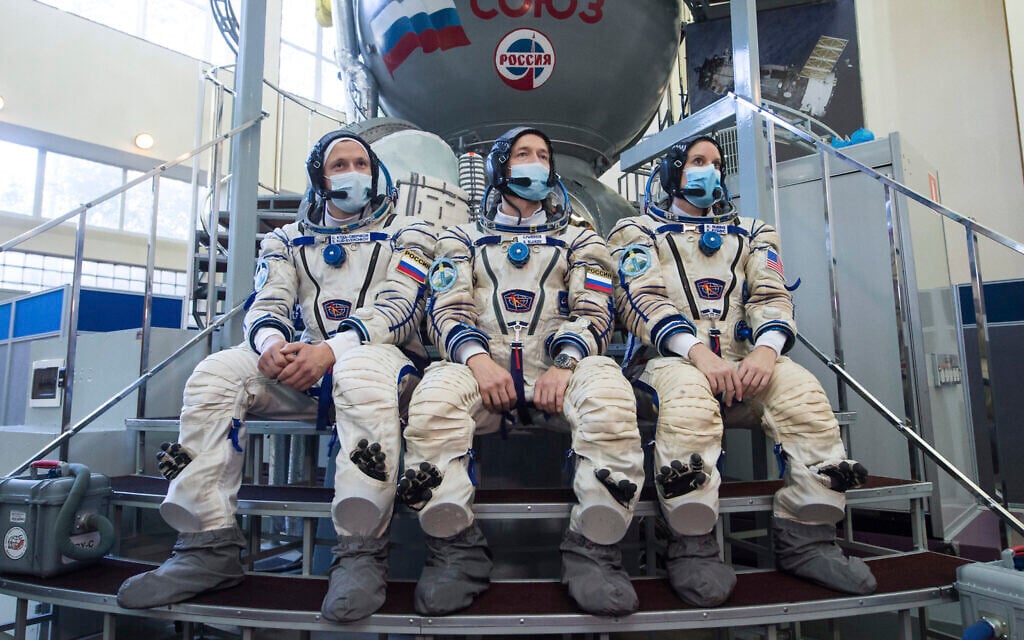 Illustrative: International Space Station (ISS) Expedition 64th crew members, from left, Russian cosmonauts Sergey Kud-Sverchkov, Sergey Ryzhikov and US astronaut Kathleen Rubins wearing face masks to protect against coronavirus pose during their final preflight practical examination in a mock-up of a Soyuz space craft at the Gagarin Cosmonaut Training Centre in Star City, outside Moscow, Russia, September 23, 2020. (Andrey Shelepin/Roscosmos Space Agency Press Service via AP)