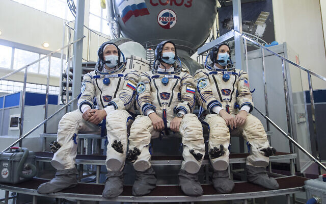 Illustrative: International Space Station (ISS) Expedition 64th crew members, from left, Russian cosmonauts Sergey Kud-Sverchkov, Sergey Ryzhikov and US astronaut Kathleen Rubins wearing face masks to protect against coronavirus pose during their final preflight practical examination in a mock-up of a Soyuz space craft at the Gagarin Cosmonaut Training Centre in Star City, outside Moscow, Russia, September 23, 2020. (Andrey Shelepin/Roscosmos Space Agency Press Service via AP) Illustrative: International Space Station (ISS) Expedition 64th crew members, from left, Russian cosmonauts Sergey Kud-Sverchkov, Sergey Ryzhikov and US astronaut Kathleen Rubins wearing face masks to protect against coronavirus pose during their final preflight practical examination in a mock-up of a Soyuz space craft at the Gagarin Cosmonaut Training Centre in Star City, outside Moscow, Russia, September 23, 2020. (Andrey Shelepin/Roscosmos Space Agency Press Service via AP)