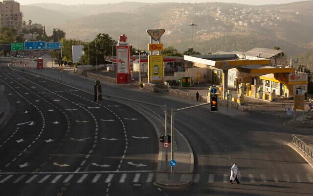 A man wears a prayer shawl as he crosses a main street on Yom Kippur in Jerusalem Sept. 28, 2020. (AP Photo/Maya Alleruzzo) A man wears a prayer shawl as he crosses a main street on Yom Kippur in Jerusalem Sept. 28, 2020. (AP Photo/Maya Alleruzzo)